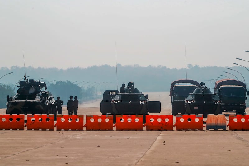 This Feb. 2, 2021, photo shows Myanmar soldiers blocking a road leading to the parliament building in Naypyidaw as hundreds of members of Myanmar's parliament remained confined inside their government housing a day after the military staged a coup and detained senior politicians including Aung San Suu Kyi.