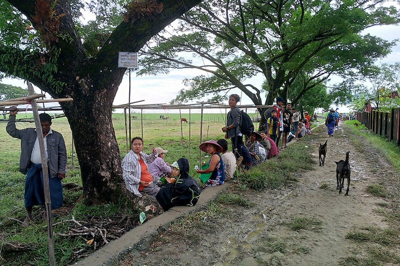 People flee from a village after fighting between Myanmar's military and the Arakan Army in Pauktaw township in western Rakhine state on Nov. 19, 2023.