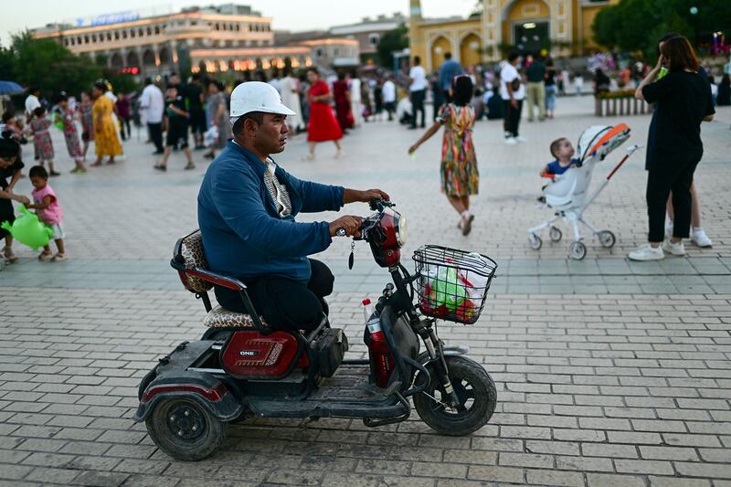 Uyghur people outside the Id Kah Mosque in Kashgar city in northwestern China's Xinjiang region, July 13, 2023.