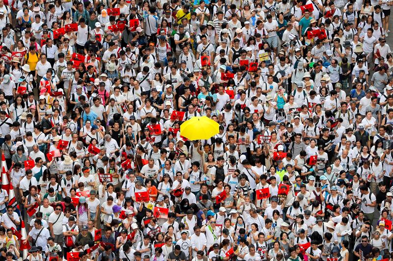 A protester holds up a yellow umbrella as he marches with thousands of others in a rally against the proposed amendments to extradition law in Hong Kong, June 9, 2019. (Kin Cheung/AP)