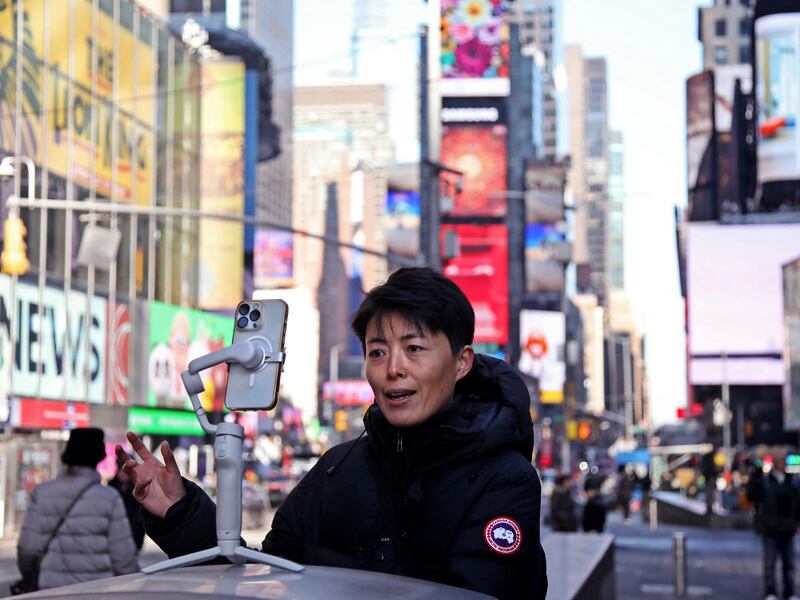 A woman records herself for social media in Times Square in New York City,  Jan. 17, 2025.